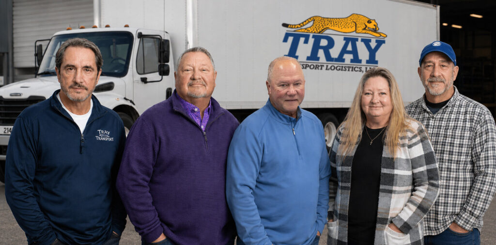 Tray Transport Logistics Team In Front Of Branded Truck